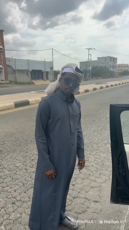 Traditional Attired Person Smokes by Overcast City Roadside – AI Generated Video | Hailuo AI