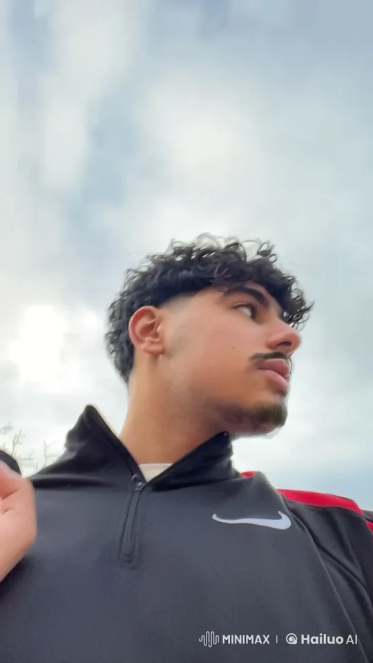 Young Man Smoking Outdoors Under Cloudy Sky – AI Generated Video | Hailuo AI