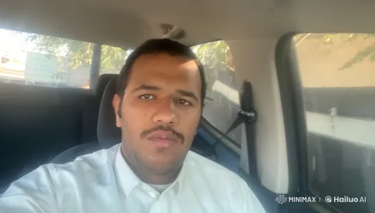 Person Smoking in Sunlit Car with Urban Greenery Background – AI Generated Video | Hailuo AI