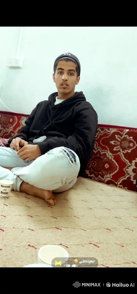 Young Man Relaxing and Smoking on Carpeted Floor – AI Generated Video | Hailuo AI