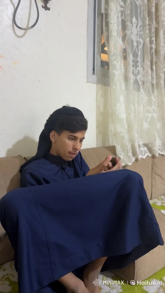 Young Man Relaxing with Cigarette on Couch – AI Generated Video | Hailuo AI