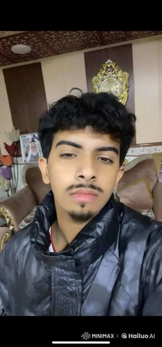 Young Man Reflects with a Smoke in a Warmly Lit Room – AI Generated Video | Hailuo AI