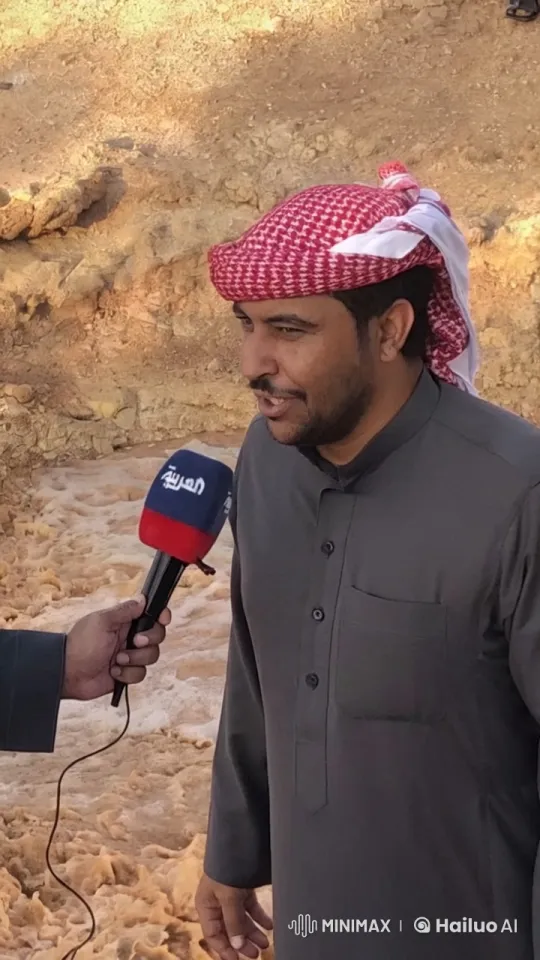 Man in Traditional Outfit Smokes, Interviewed in Rocky Terrain – AI Generated Video | Hailuo AI