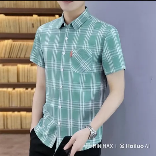 Young Man in Plaid Shirt With Smartphone Against Purple Wall – AI Generated Video | Hailuo AI