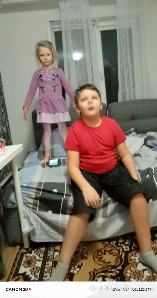 Girl in Purple Dress Playfully Aims Rocket Launcher at Boy – AI Generated Video | Hailuo AI