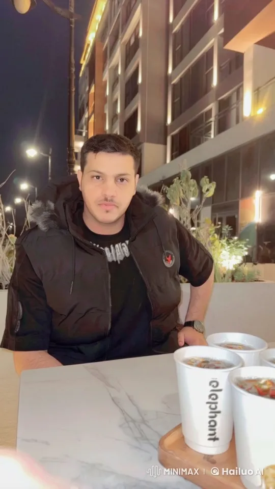 Night Reflections: Man Smokes by Modern Building – AI Generated Video | Hailuo AI