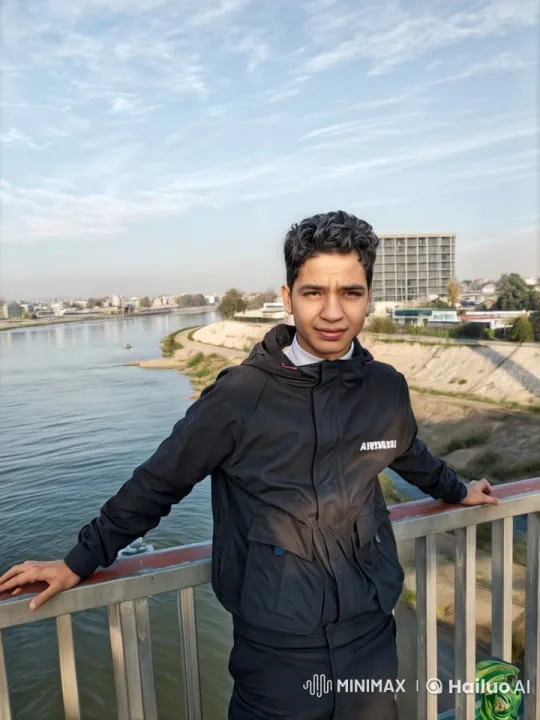 Young Man Contemplates by the River on a Calm Day – AI Generated Video | Hailuo AI