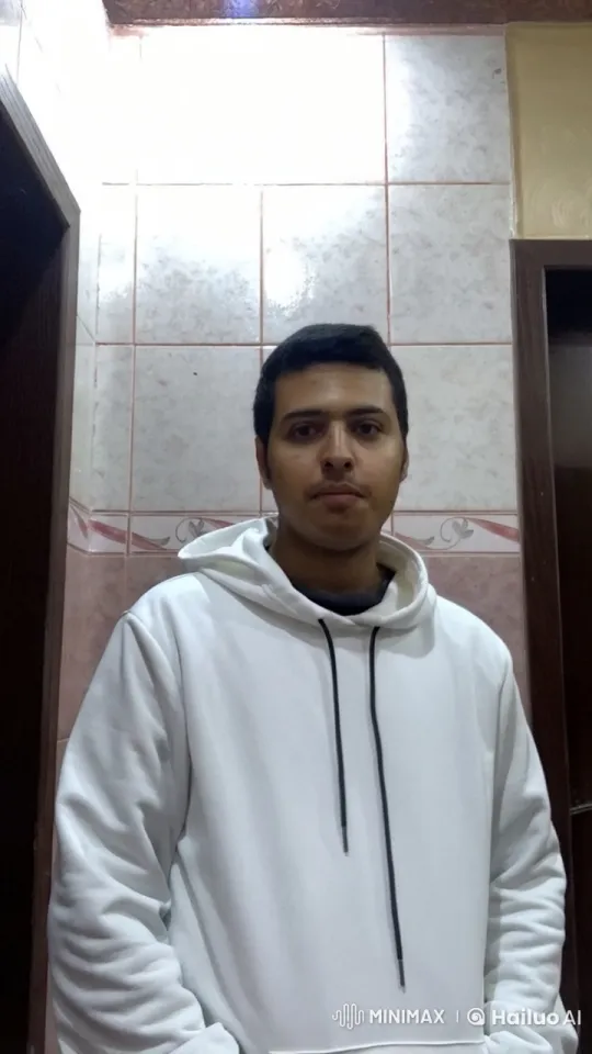 Young Man in White Hoodie Approaches Camera – AI Generated Video | Hailuo AI