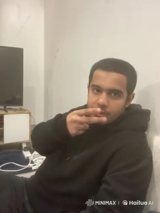 Casual Person Smoking in Dimly Lit Room – AI Generated Video | Hailuo AI