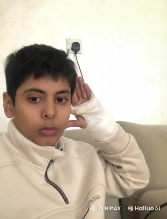 Contemplative Person Simulates Smoking on Beige Couch – AI Generated Video | Hailuo AI
