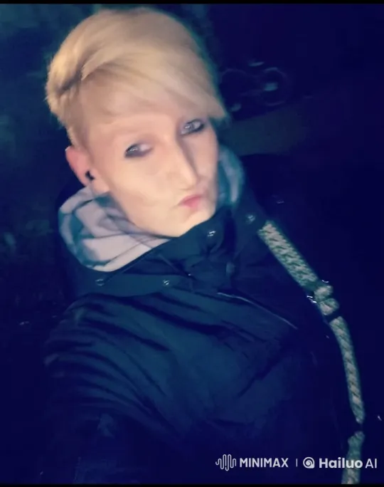 Blonde Takes Spontaneous Selfies in Mysterious Dark Setting – AI Generated Video | Hailuo AI