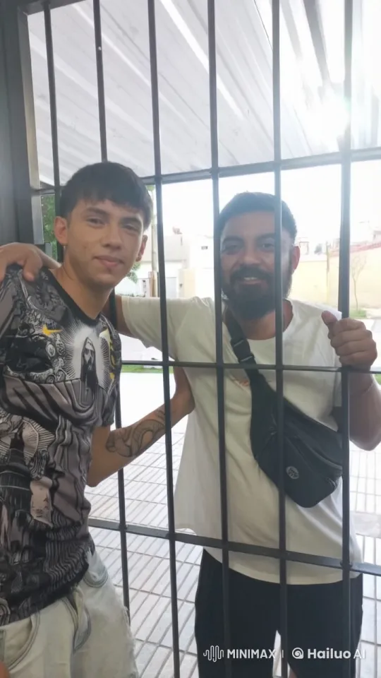 Two Men Share Intimate Kiss Through Gate – AI Generated Video | Hailuo AI