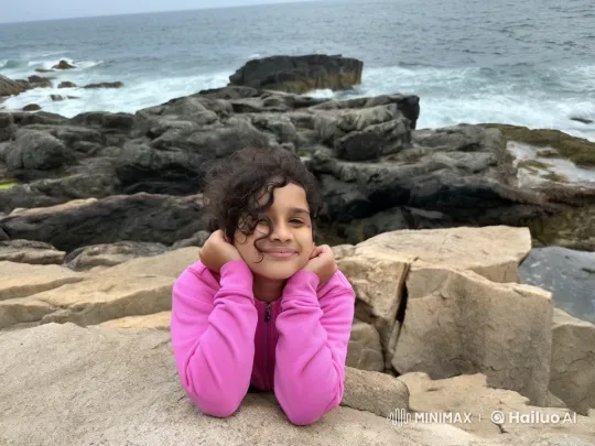 Young Girl Surprised by Large Wave at Rocky Shore – AI Generated Video | Hailuo AI
