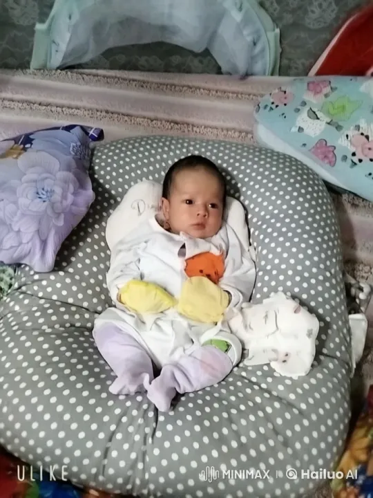 Baby Relaxing on Polka-Dotted Cushion in Cozy Setting – AI Generated Video | Hailuo AI