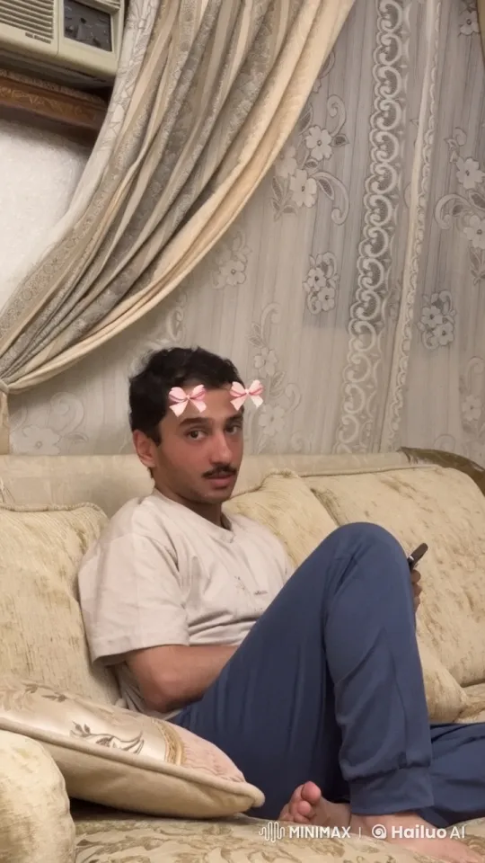 Man Relaxing on Couch Smoking and Using Smartphone – AI Generated Video | Hailuo AI