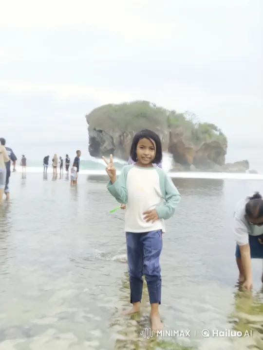 Child Giving Peace Sign at Beach with Gentle Waves – AI Generated Video | Hailuo AI