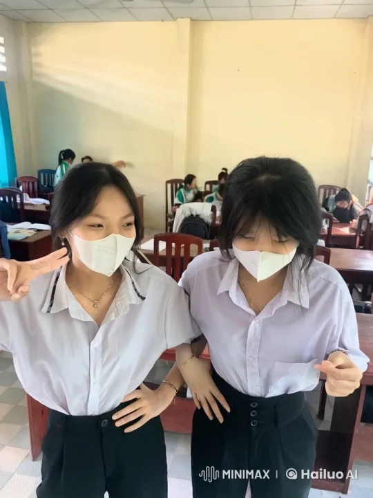 Two Young Women Pose Confidently in Bright Classroom – AI Generated Video | Hailuo AI