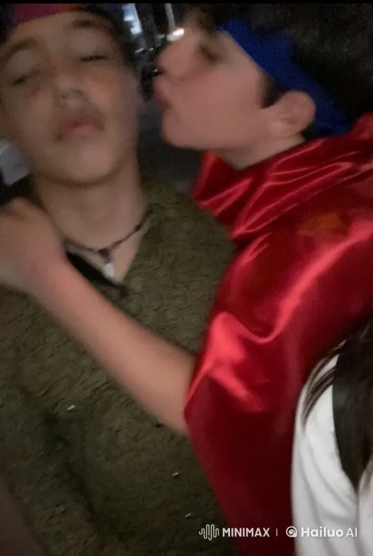 Two Boys Share Intimate Moment in Dimly Lit Setting – AI Generated Video | Hailuo AI