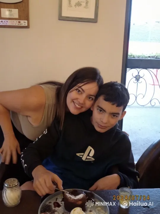 Adolescent Boy and Woman Playfully Struggle Over Dessert – AI Generated Video | Hailuo AI