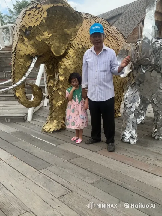 Child and Elderly Man Practice Kung Fu in Front of Metallic Elephants – AI Generated Video | Hailuo AI