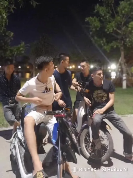 Young Men Socializing Around Motorbikes at Night – AI Generated Video | Hailuo AI