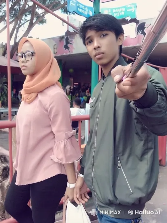 Couple Taking Selfie at Amusement Park Entrance – AI Generated Video | Hailuo AI