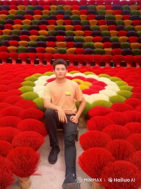 Young Man Amidst Swaying Incense Bundles – AI Generated Video | Hailuo AI