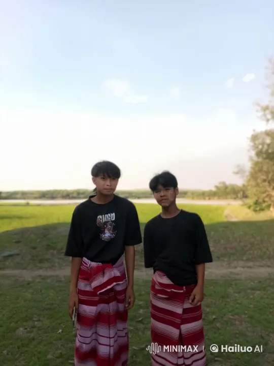 Boys in T-shirts and Sarongs Play-Fight in Scenic Field – AI Generated Video | Hailuo AI