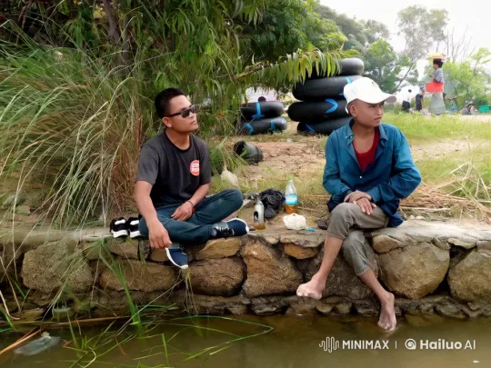Friends Relaxing by a Stream with River Tubing Gear – AI Generated Video | Hailuo AI