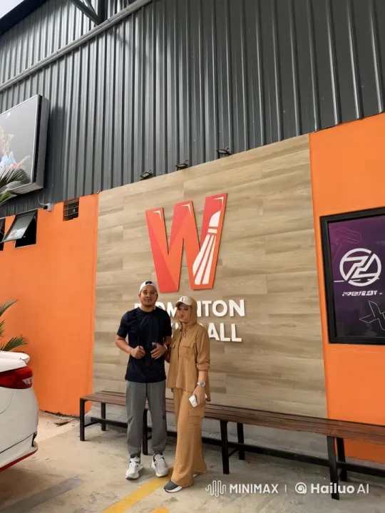Couple Demonstrates Martial Arts in Front of Badminton Wall – AI Generated Video | Hailuo AI