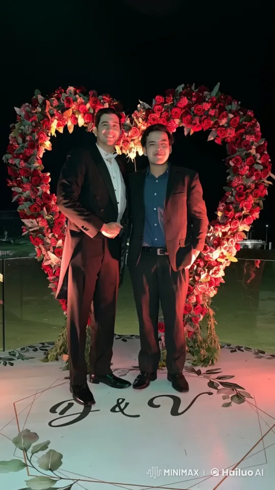 Formal Men Share Affectionate Moment in Rose Archway – AI Generated Video | Hailuo AI