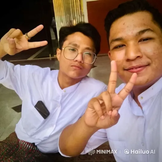 Friends in Traditional Attire Share Peace Sign and Warm Embrace – AI Generated Video | Hailuo AI