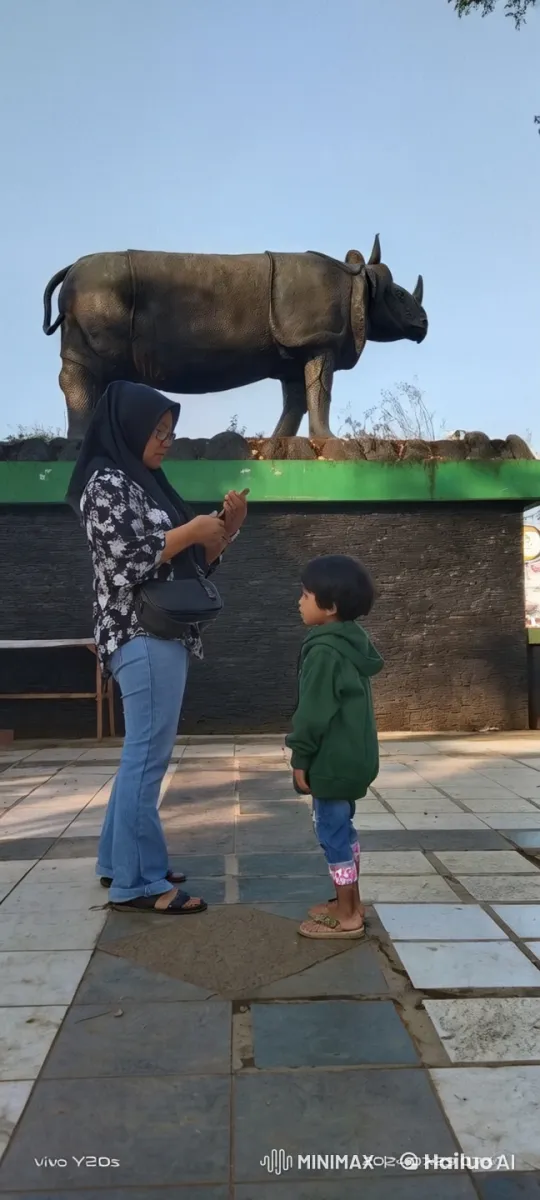 Woman and Child Perform Kungfu in Front of Bull Statue – AI Generated Video | Hailuo AI