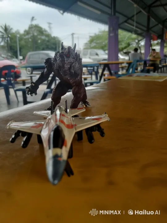 Toy Jet and Giant Figurine Dance Playfully – AI Generated Video | Hailuo AI