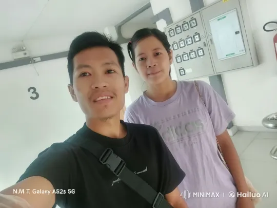 Two Individuals Posed for a Photo in a Clean Indoor Setting – AI Generated Video | Hailuo AI