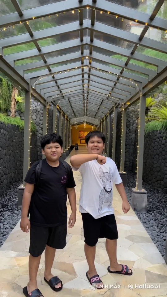 Two Young Men Enjoying a Festive Open-Air Hallway – AI Generated Video | Hailuo AI