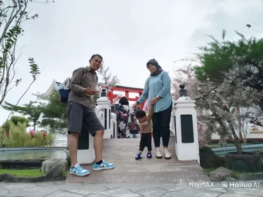 Family Poses by Blossoming Bridge, Kids Play Kung Fu – AI Generated Video | Hailuo AI