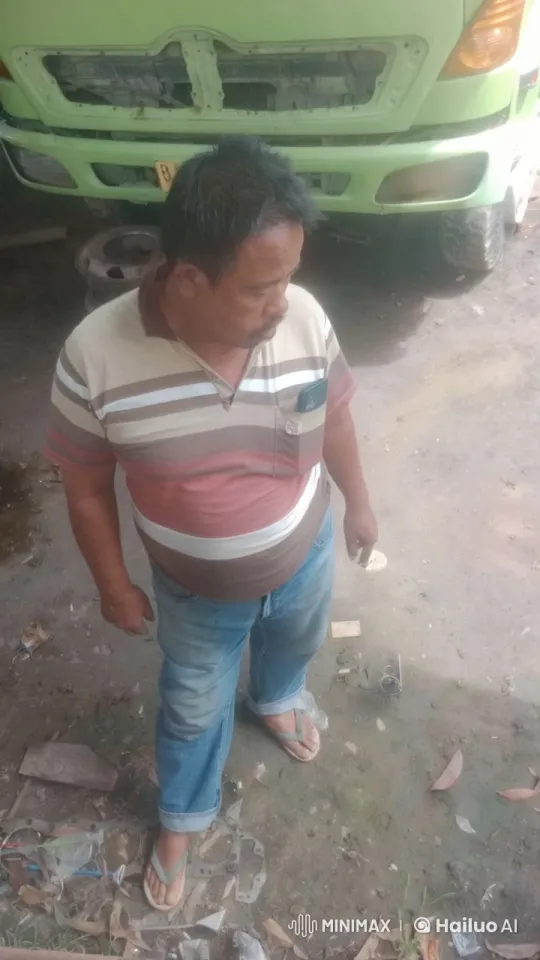 Man Repairing Green Vehicle in Garage Workshop – AI Generated Video | Hailuo AI