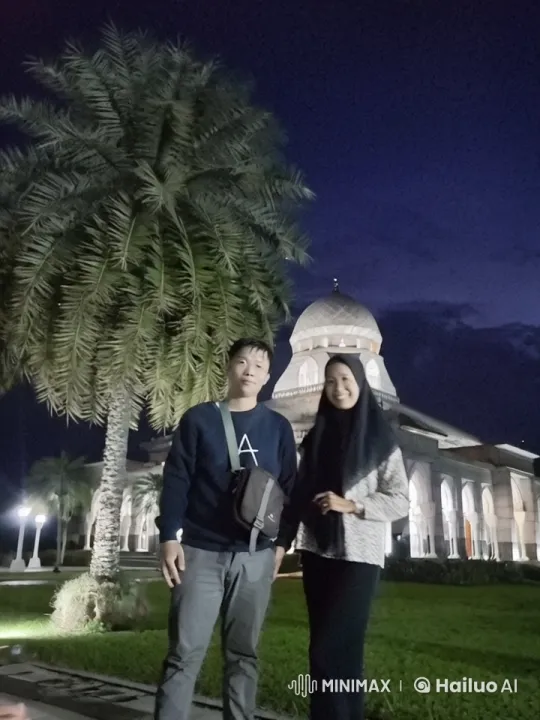 Nighttime Portrait of Couple Near Lit Mosque – AI Generated Video | Hailuo AI