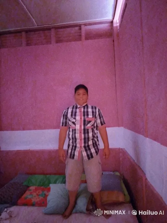 Muscular Man Relaxing on Colorful Bed in Cozy Room – AI Generated Video | Hailuo AI