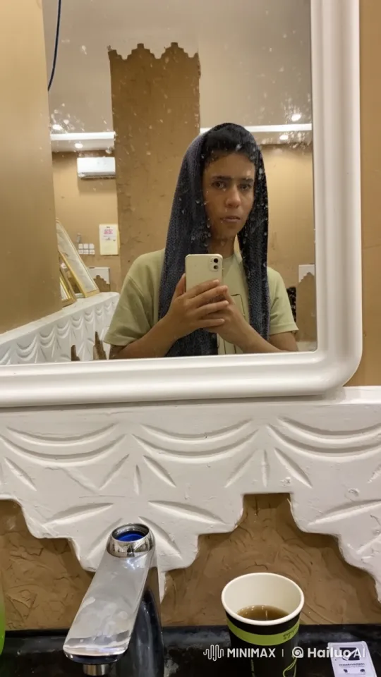 Person Reflecting in Bathroom Mirror with Smartphone – AI Generated Video | Hailuo AI