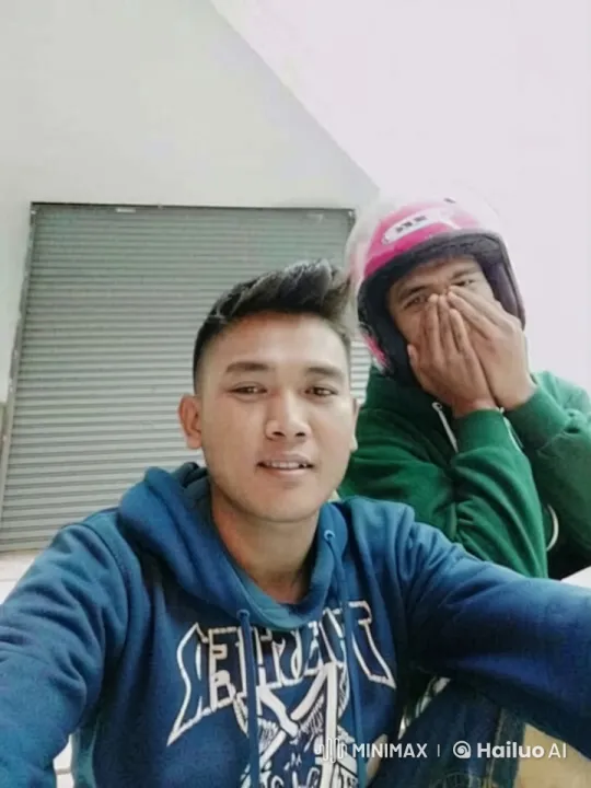 Two People in Hoodies Adjusting Helmets Indoors – AI Generated Video | Hailuo AI