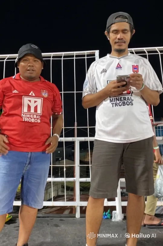 Two Individuals in Soccer Jerseys Overlooking Night Stadium – AI Generated Video | Hailuo AI