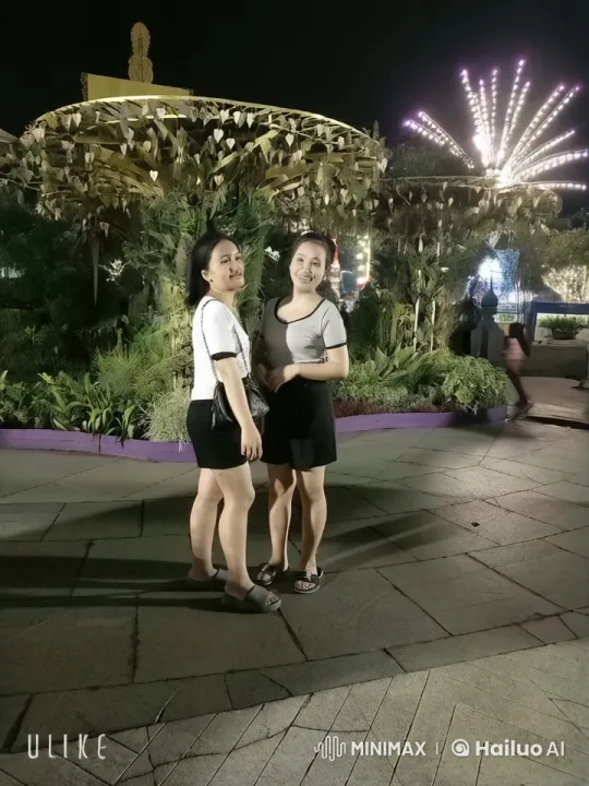 Nighttime Festival: Women by Decorated Gazebo – AI Generated Video | Hailuo AI