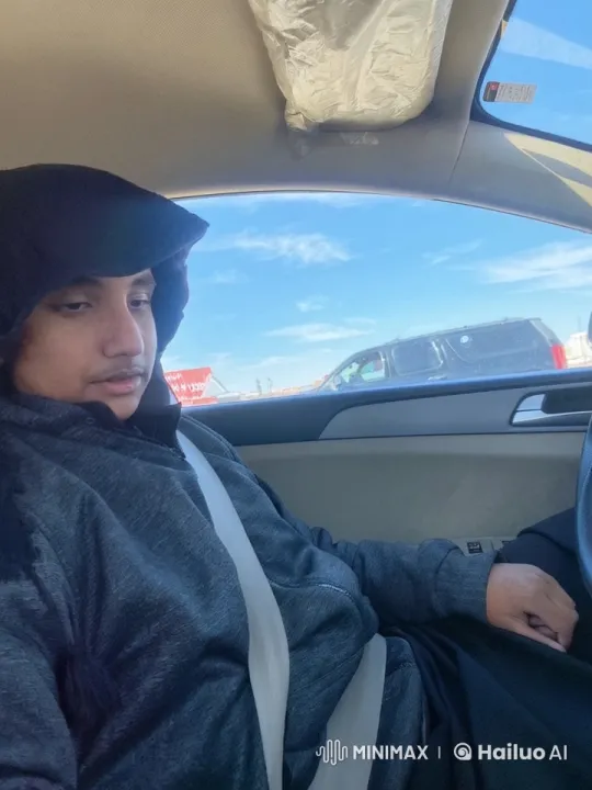 Relaxed Person Smoking in Parked Car with Clear Sky – AI Generated Video | Hailuo AI