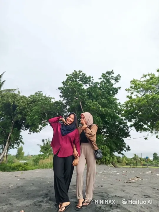 Two Women Pose Cheerfully on a Serene Beach – AI Generated Video | Hailuo AI