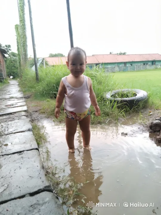 Child Playing in Puddle on Cloudy Day – AI Generated Video | Hailuo AI