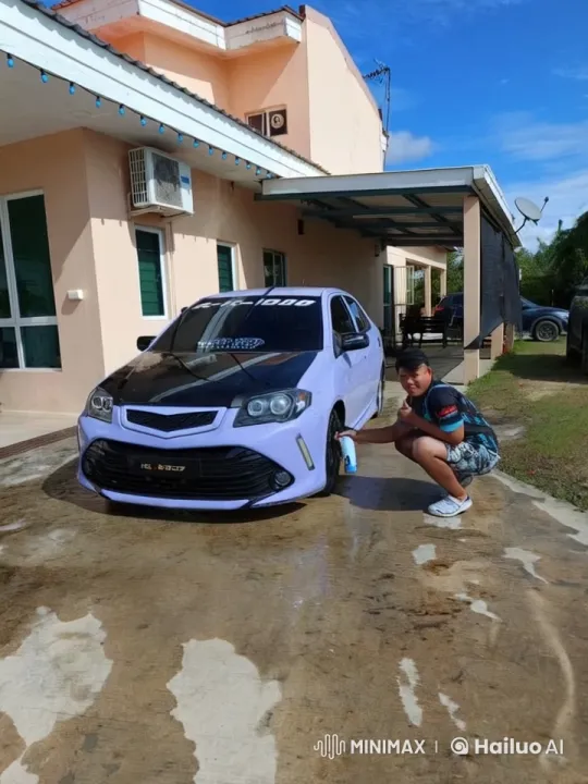 Man Cleaning Car Wheel in Front of House – AI Generated Video | Hailuo AI