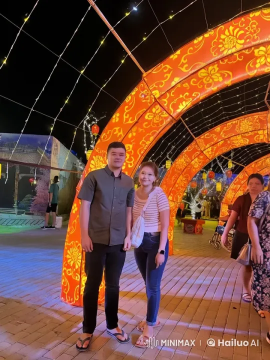 Couple Enjoying Festive Atmosphere Under Red Arches – AI Generated Video | Hailuo AI