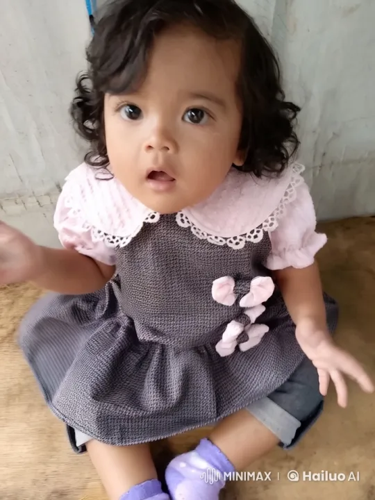 Child in Charming Outfit Plays on Wooden Floor – AI Generated Video | Hailuo AI